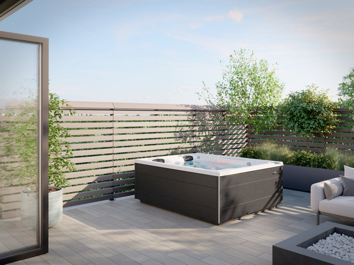 Jacuzzi J-4 Collection hot tub on a modern outdoor patio, available at Jacuzzi Hot Tubs Rochester, NY.