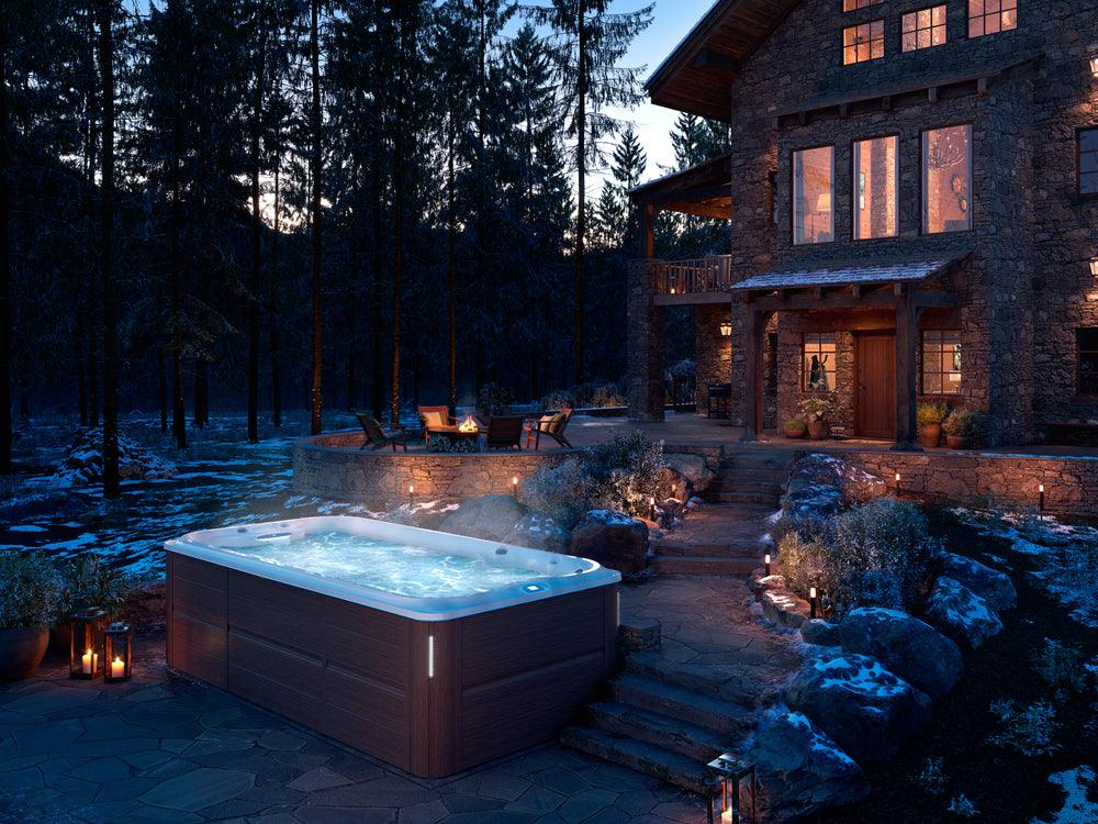 Jacuzzi® PowerActive™ Swim Spa on a back patio, available at Jacuzzi Hot Tubs Rochester, NY.