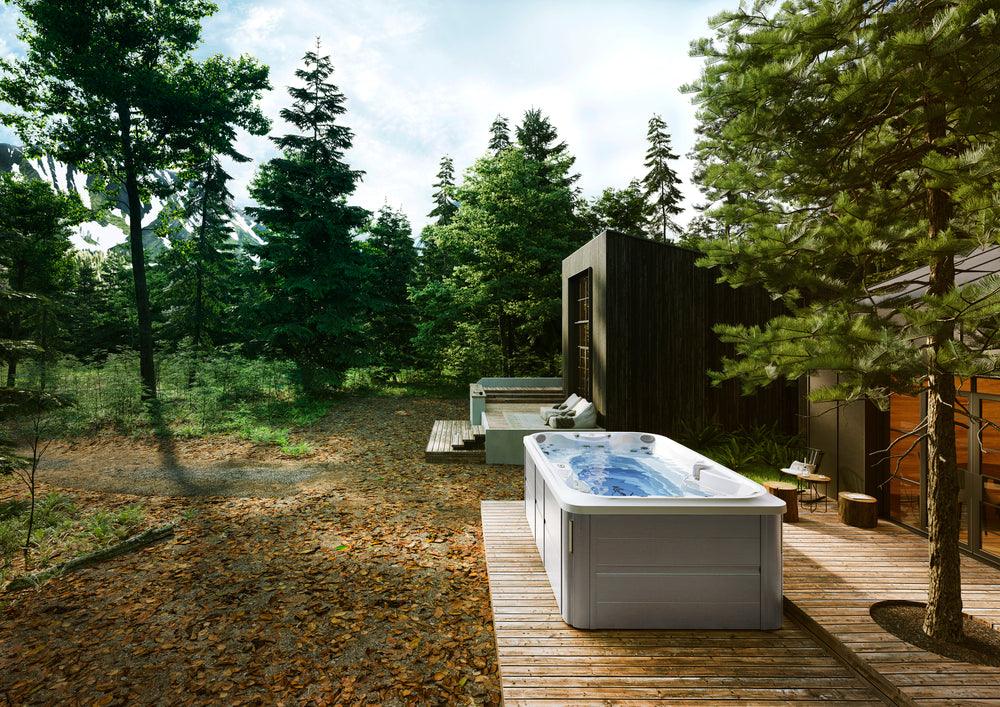 Jacuzzi® PowerPlay™ Swim Spa on a wooden deck, available at Jacuzzi Hot Tubs Rochester, NY.