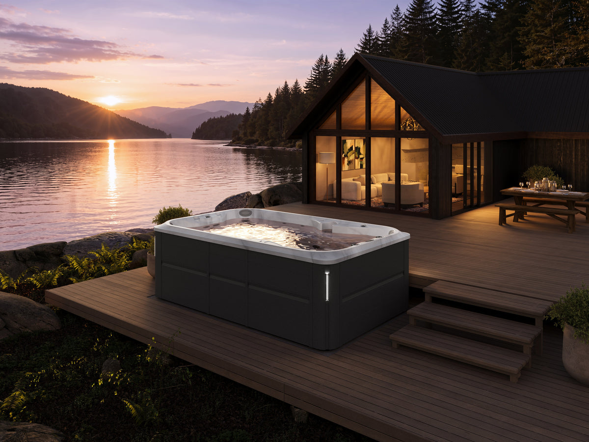 acuzzi swim spa on a wooden backyard deck outside a modern cabin next to a lake in Rochester, NY.